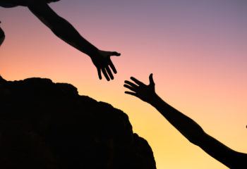 two hands reaching for each other