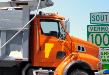 photo of dump truct near Vermont route signs
