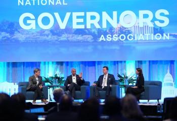Tim Shriver with Governor Wes Moore, Governor Kevin Stitt, and Laura Collins from the George W. Bush Institute on stage at the 2026 National Governors Association meeting