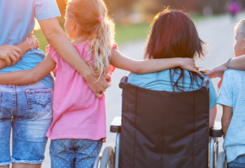 family facing sunset