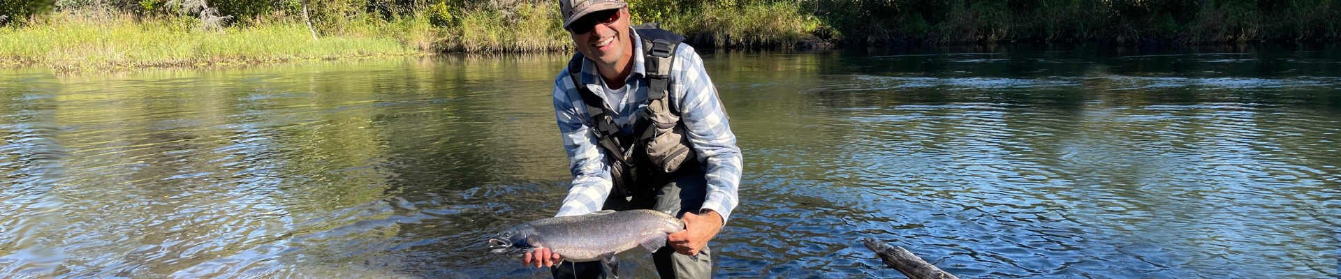 Josh holding a freshly caught fish