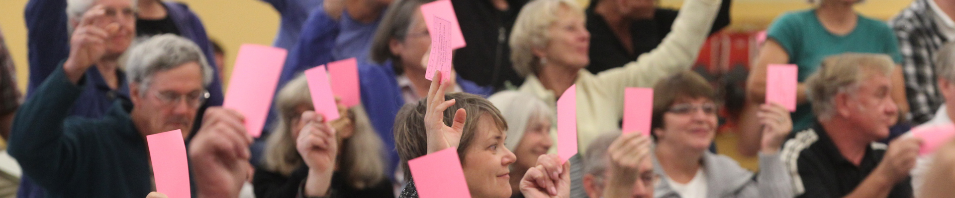 Crowd of people holding up sticky notes