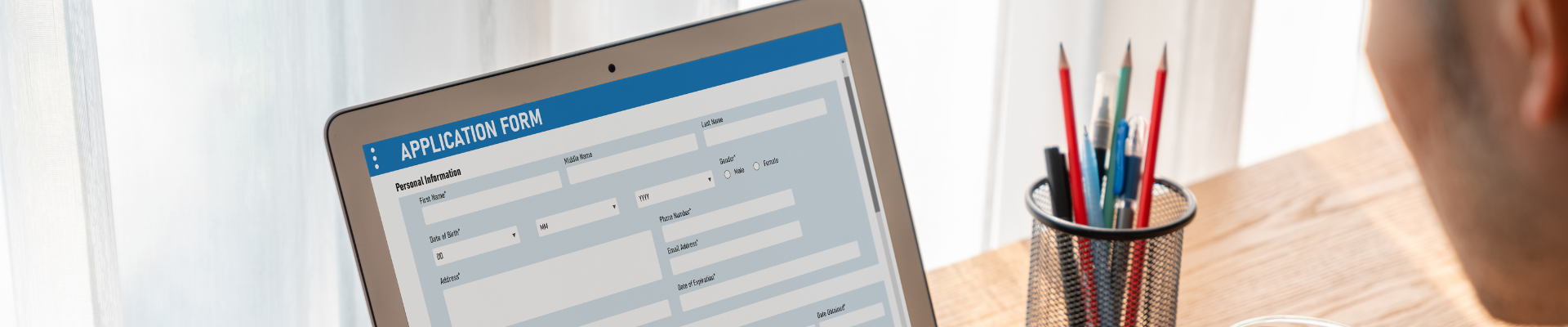 person filling out application form on the computer