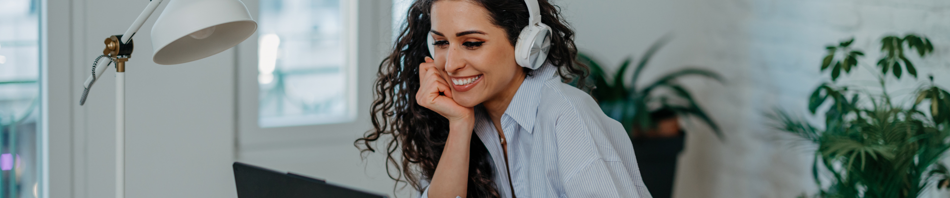Person with headphones talking via computer