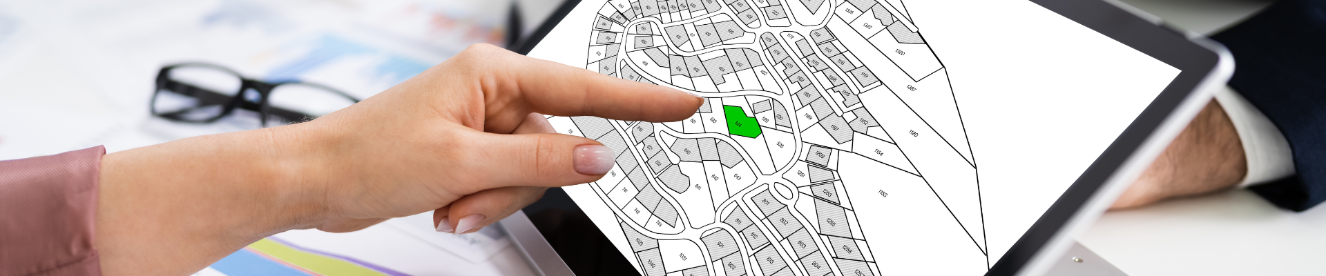 finger pointing at map on computer screen