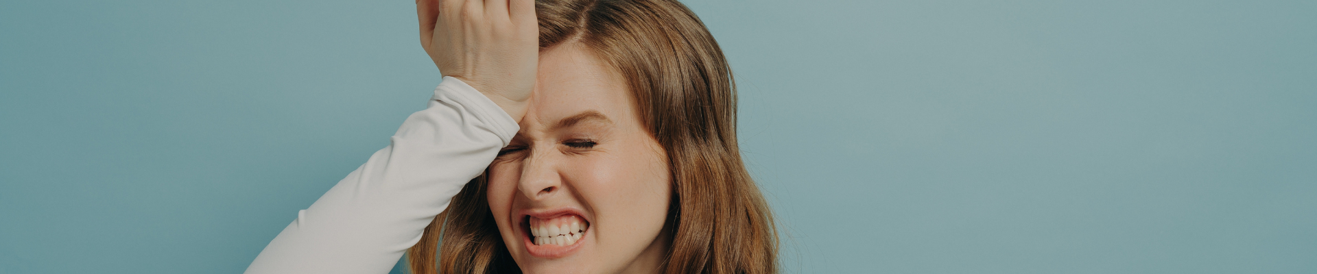 frustrated woman with hand on forehead