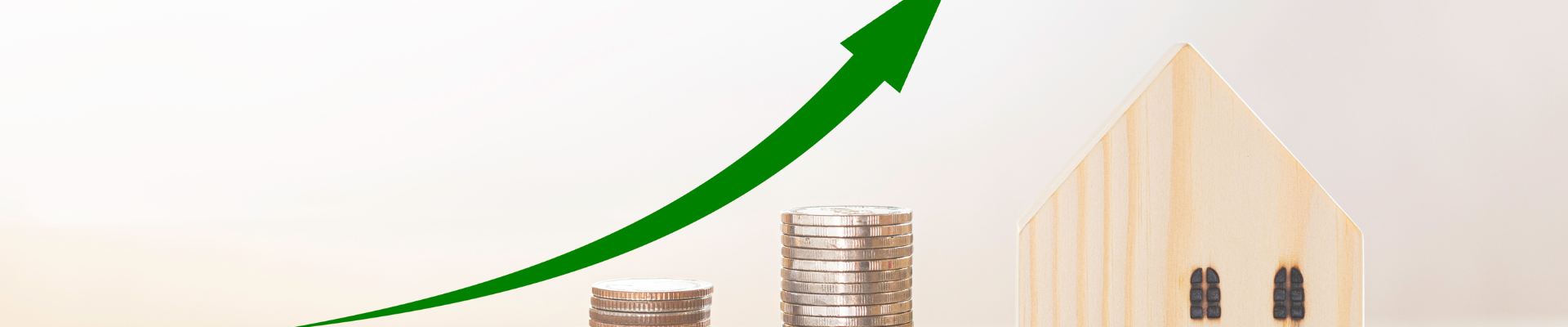 upward growth line over stacks of coins ending in a wooden house