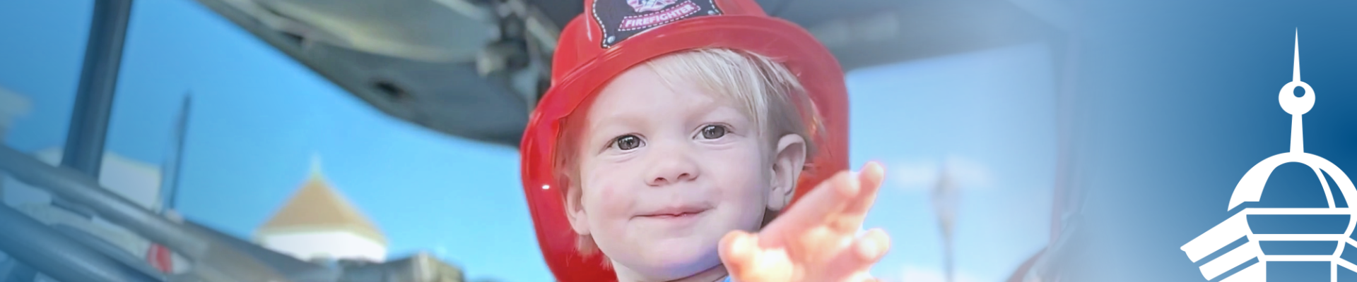 Young child wearing firefighter-style hat in a snippet from the cover of VLCT's 2022 annual report