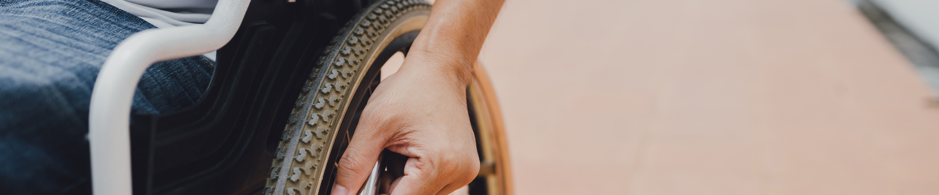 hand on wheelchair wheel 