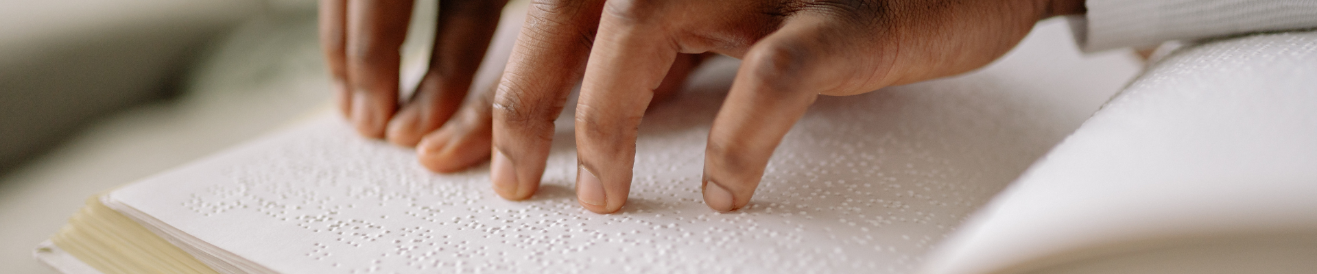 hands reading braille 