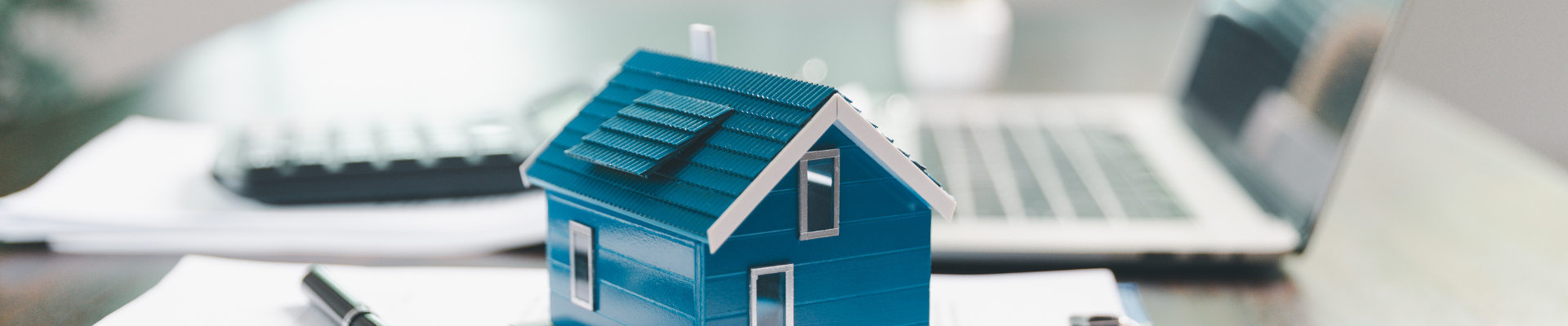 house model placed on table alongside paperwork symbolizing property valuation