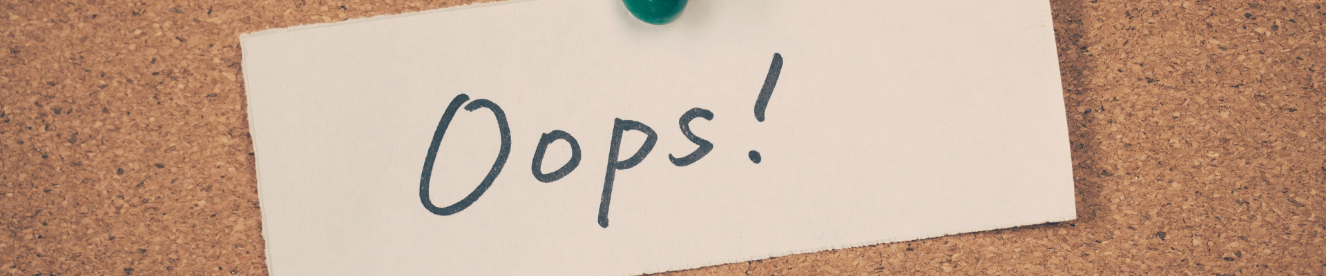 note on bulletin board saying "Oops!"