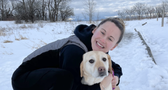 photo of Allie outdoors in winter hugging her dog, superimposed on four-leaf clovers