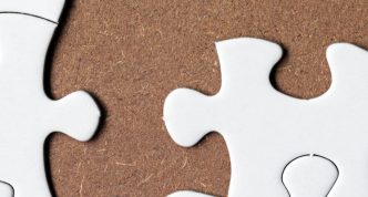 white jijgsaw puzzle with sevreal pieces missing