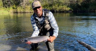 Josh holding a freshly caught fish