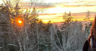 photo of Julie beside a beautiful Vermont sunset