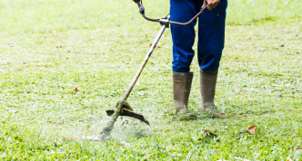 photo of a person from the waist down using a weed whacker