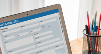 person filling out application form on the computer