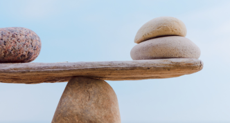 a single rock and two rocks balanced on a central rock point
