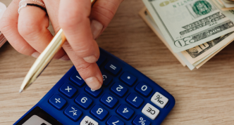 woman calculating money and receipts using calculator