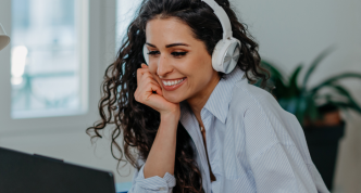 Person with headphones talking via computer