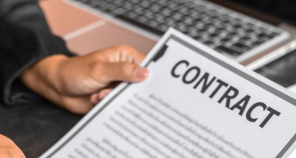 photo of hands offereing a contract to be signed