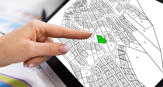 finger pointing at map on computer screen