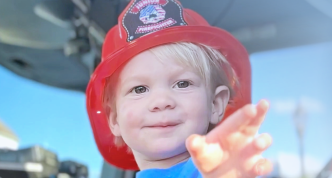 Young child wearing firefighter-style hat in a snippet from the cover of VLCT's 2022 annual report