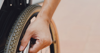 hand on wheelchair wheel