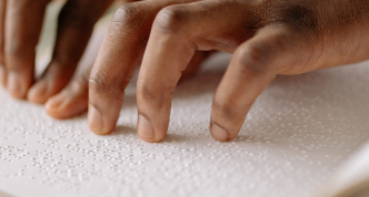 hands reading braille