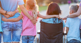 family facing sunset