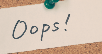 note on bulletin board saying "Oops!"