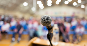 microphone on stage facing crowd