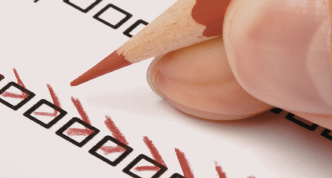 hand holding pencil and completing an assessment