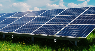 a large array of solar/PV panels in a field