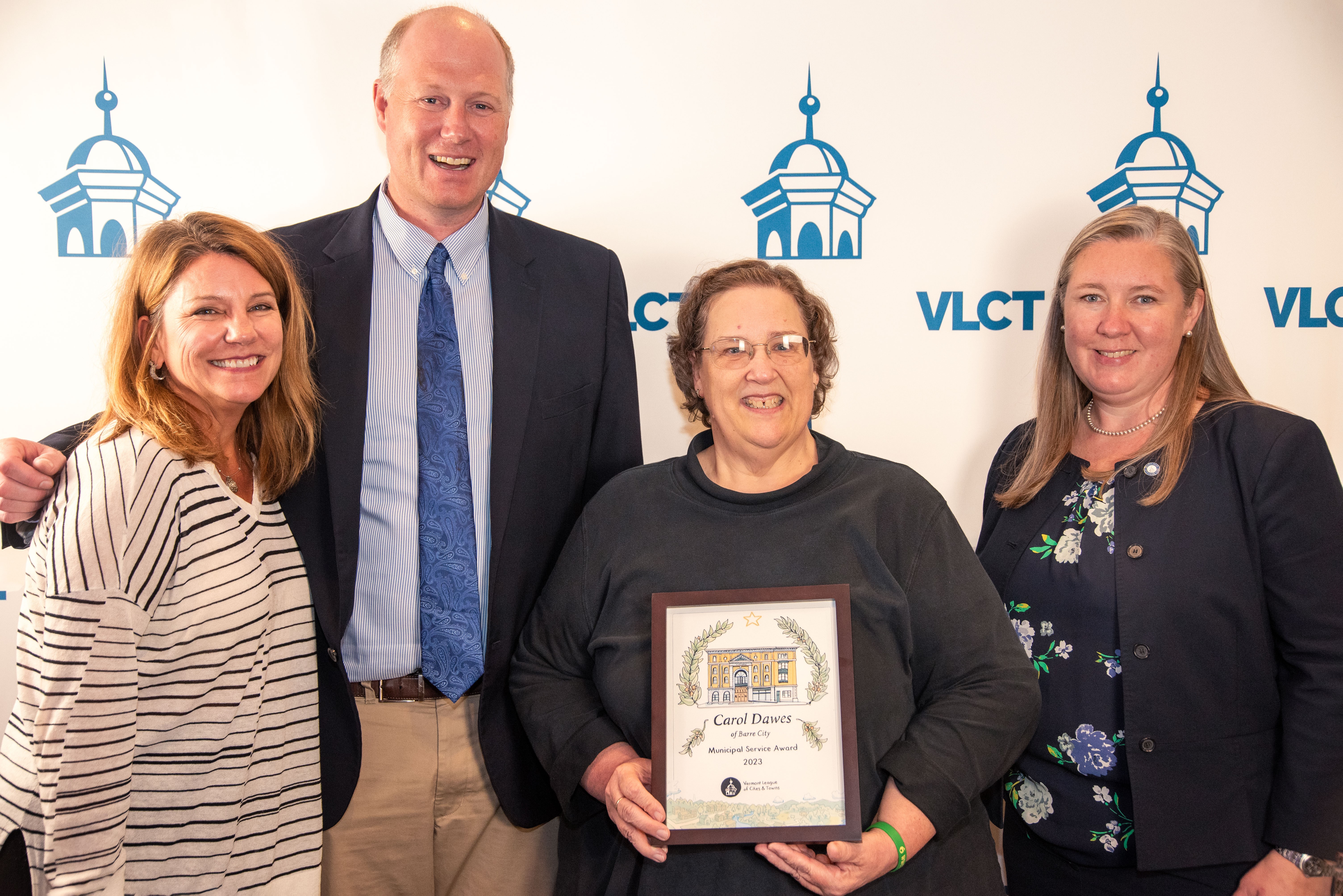 Presenting the 2023 VLCT Municipal Service Award were (l-r) West Rutland Town Manager  and VLCT board member Mary Ann Goulette, VLCT Executive Director Ted Brady, Barre City Clerk and Treasurer Carol Dawes, and VLCT Immediate Past President Jessi Baker.